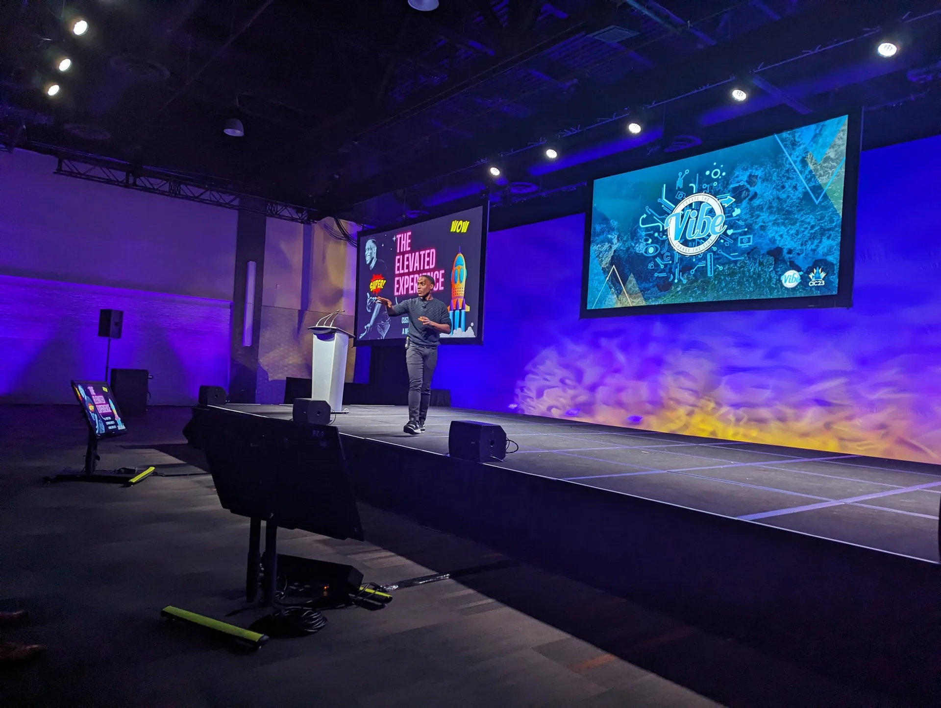 Daniel Lewis speaking on stage
