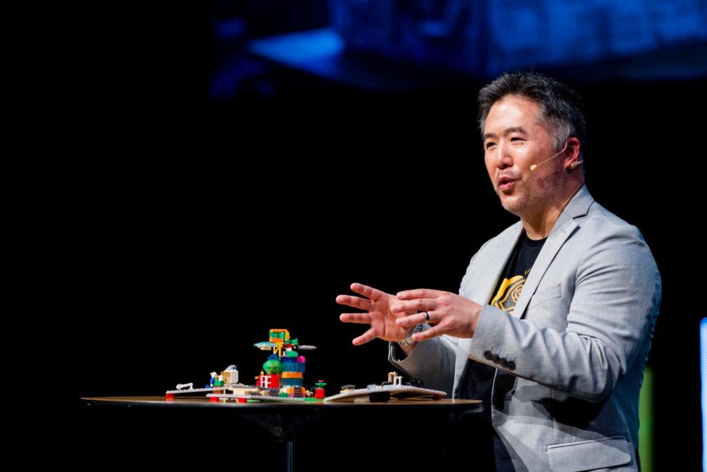Leo Chan speaking with a LEGO® build on the table